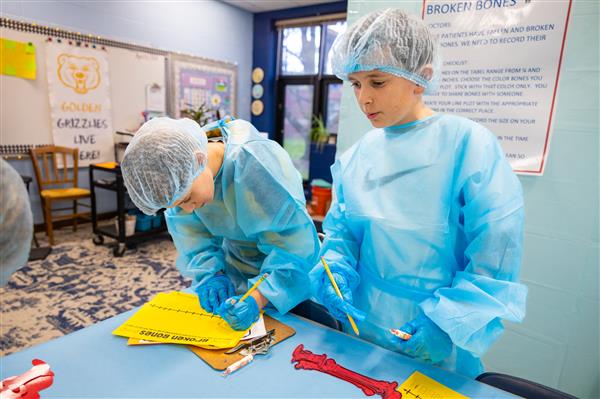 students in scrubs working at tables
